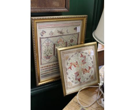 A small embroidered picture depicting fish together with a needlework sampler.