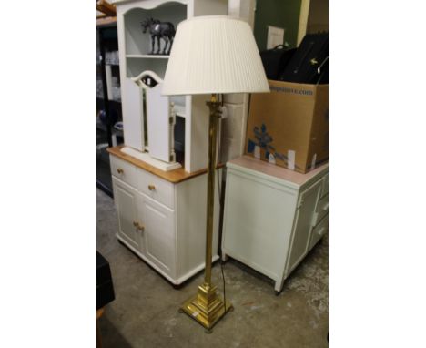 A brass floor standing lamp.