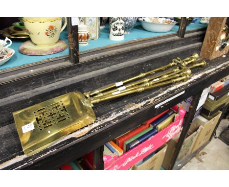 Five brass fireside tools.