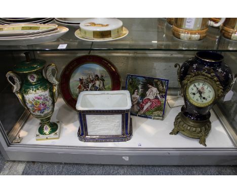 A decorative ornamental porcelain table lamp with floral decoration, a continental porcelain cased clock and other items.