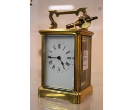 A brass carriage clock.