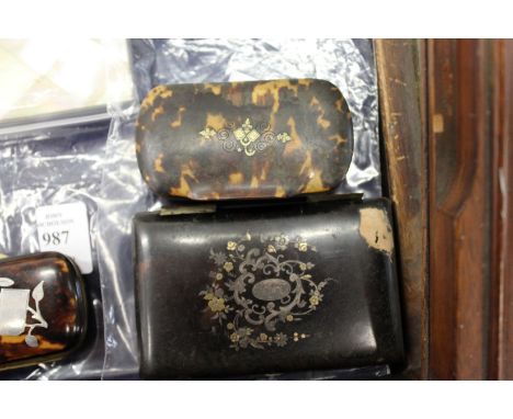 A tortoiseshell snuff box and a folding case.