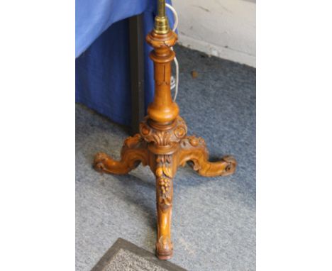 A good carved walnut and brass tripod lamp standard.