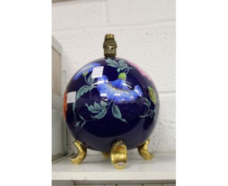 A floral decorated globe shaped lamp base.