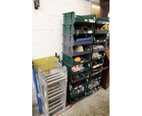 A folding ladder Workmate and a quantity of storage shelves containing numerous tools.