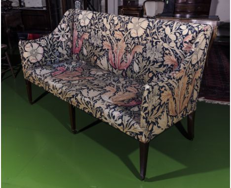 A late 18th early 19th century sofa with mahogany tapered legs and brass castors