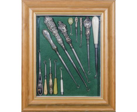 A mounted and framed collection of silver and tortoiseshell handled button hooks