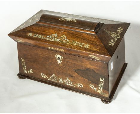 A rosewood tea caddy with mother of pearl inlay, fitted interior