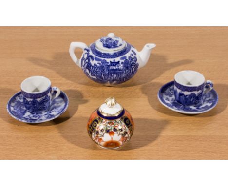 A miniature Crown Derby lidded bowl, miniature blue and white teapot and two cups and saucers