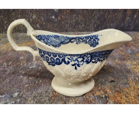 A Liverpool John &amp; Jane Pennington cream jug, moulded in relief with stiff leaves,&nbsp;printed in underglaze blue with d