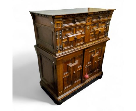 An 18th century oak and walnut house keeper's cupboard or buffet,&nbsp;geometric and half bobbin turned moulding, oversailing