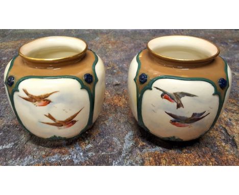 A pair of Royal Worcester Hadley style vases,&nbsp; moulded with panels and painted with birds in flight, gilt line borders, 