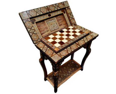 A 19th century Anglo Indian games compendium, the folding vizagapatam/micromosaic inset table opens to reveal an impressive b