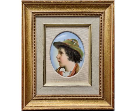 A 19th century German porcelain oval plaque, probably Berlin, portrait of a young boy wearing a hat, oval, 12.5cm x 9.5cm, la