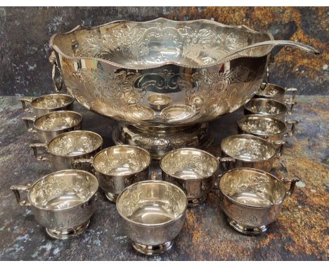 A large silver plated on copper punch bowl, engraved and chased with flowers and acanthus leaves, lion mask ring loop handle,