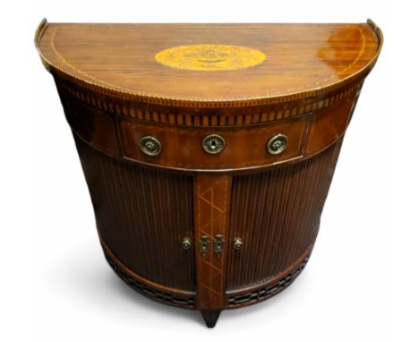 An 18th century Dutch mahogany tambour fronted demi lune side table, small drawer to frieze, tambour doors enclosing shelving