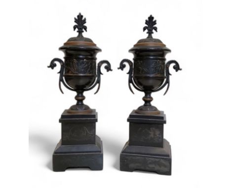 A pair of late 19th century black marble side vases, of urnular form, banded in relief after the antique, flying scroll handl
