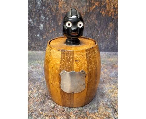 An early 20th century novelty tobacco biscuit barrel, the cover with comical black man finial, with wide eyes, 13.5cm high, c