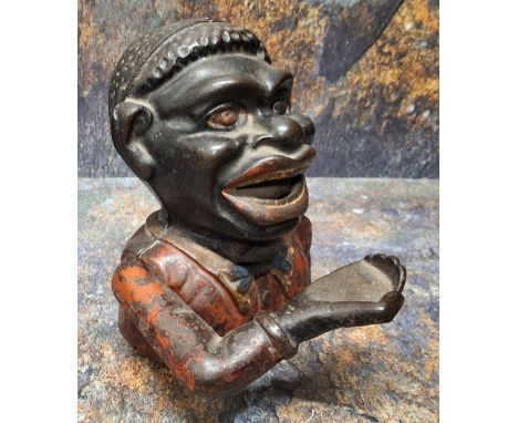 A Victorian cast iron Jolly Black Man money bank, 15cm high hese items are listed on the basis they are illustrative of a byg