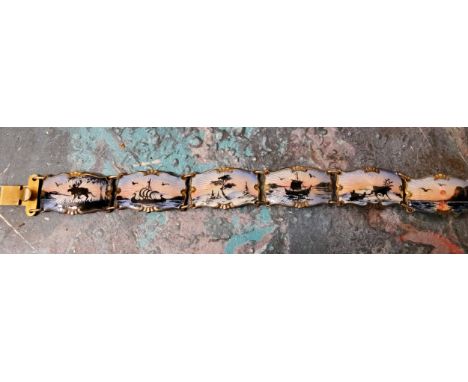 A Norwegian silver-gilt and enamel bracelet, Ivan T Holth, the panels depicting Nordic scenes, 27.82g 