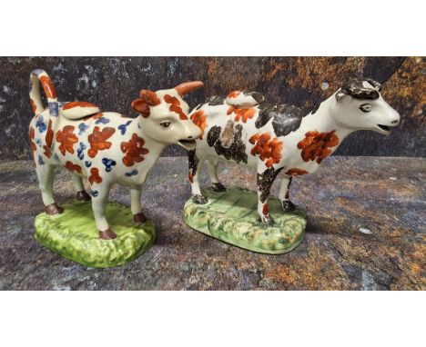 A North of England cow creamer, standing four square, with black and rust stylised patch markings, rounded rectangular base, 