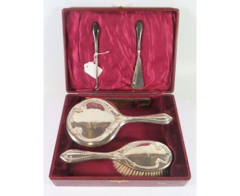 A George V Cased Silver Backed Mirror, Brush and Comb Set, Birmingham 1919, Williams (Birmingham) Ltd. and tortoise shell han