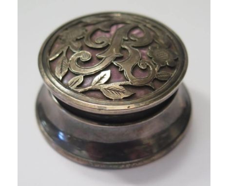 A George V Silver Patch Pot with a pink guilloché enamel top beneath a pieced foliate engraved cover bearing the initial 'R',