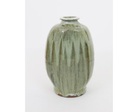 •Mike Dodd (born 1943) a tall, cut-sided stoneware vase, shouldered with collar rim, covered in a running thick ash glaze for