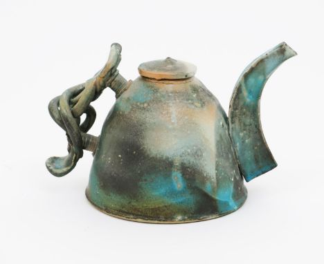 •Colin Pearson O.B.E. (1923-2007) a stoneware teapot and cover,  with applied spout and scroll handle, covered in a pitted bl