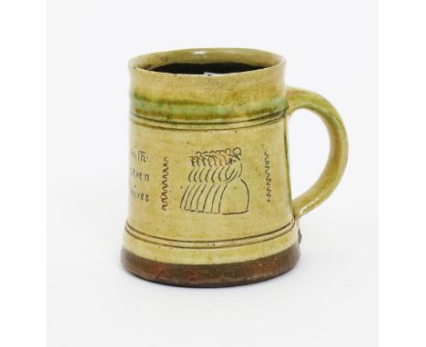 •Bernard Leach (1887-1979) attributed a Leach Pottery mug, covered to the foot with a pale yellow glaze, incised with proverb