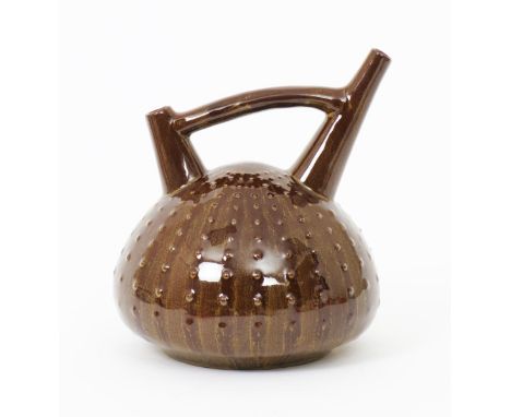 A Linthorpe Pottery ewer designed by Dr Christopher Dresser,  the body modelled as an urchin, with twin spouts and bridged ha