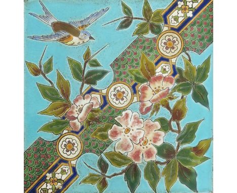 A Longwy Pottery Aesthetic Movement tile, enamelled with a bird flying past  flower stems and a geometric border, in colours 