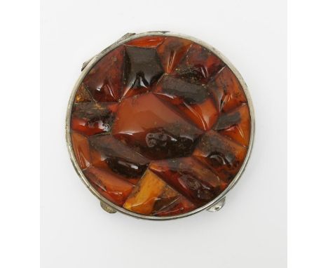 A large Russian samorodok silver and amber compact,  circular, the hinged cover set with panels of Amber inset with impuritie