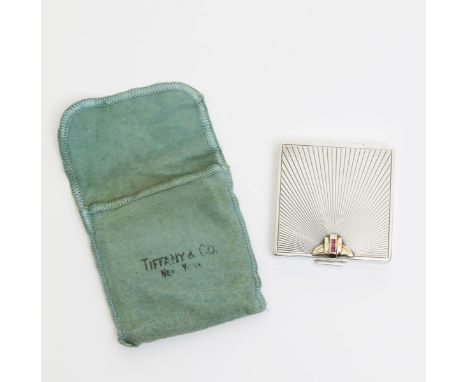 A Tiffany & Co compact, square section, L'Odeon style with radiating sunburst, set with yellow metal geometric clasp with thr