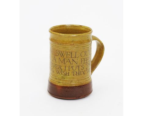 •Michael Cardew (1901-1983) a Winchcombe Pottery mug, cylindrical form with strap handle, incised with a drinking motto Brand