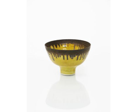 •Dame Lucie Rie D.B.E (1902-1995) a porcelain footed bowl, covered to the foot with a yellow glaze, the rim with running mang