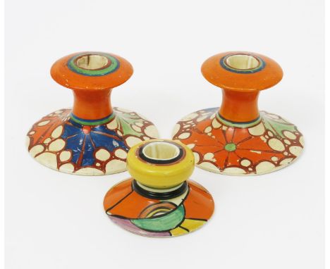 'Swirls' a Clarice Cliff Bizarre candlestick, shape no.331, painted in colours, and a pair of Broth 310 candlesticks printed 