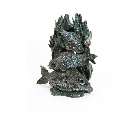 A large Poole Potter Studio sculpture by Tony Morris, deeply modelled as a tower of scaly fish, glazed in shades of green and