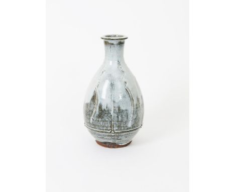 Jim Malone (born 1946) an Ainstable Pottery vase, fluted, bottle form, incised with simple comb decoration, covered in a runn