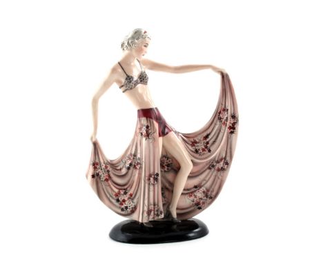 A Goldscheider Pottery figure of a dancer cast from a model by Stephan Dakon, model no.8127, modelled holding the hem of her 