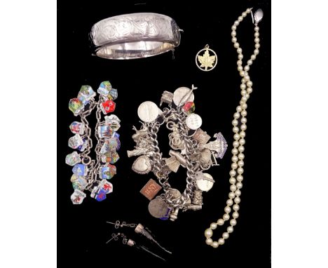 Silver charm bracelet, charms including lady on horseback, bagpipe, 'why worry' swivel and money box, silver enamel town char