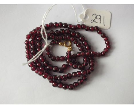 String of garnet beads with 18ct gold clasp    