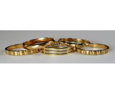 A collection of five 9ct gold hinged bangles, of varying designs, approx 82g. (5)
 CONDITION REPORT: The diamond cut bangle w