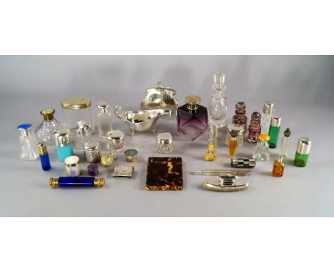 A collection of silver topped glass scent bottles and dressing table pots, various dates and makers, together with further sc