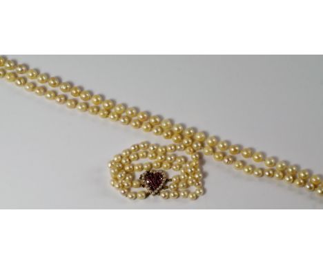A single rope of pearls, approx 112cm long, the pearls between approx 8-10mm diameter, together with a double row pearl brace