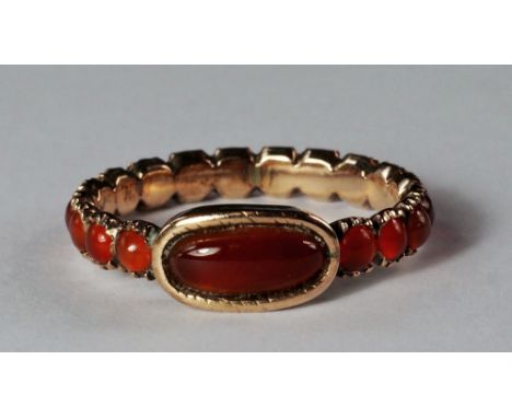 A Georgian carnelian ring, the unmarked yellow metal with central oval cabochon bezel set carnelian, the shank made of round 