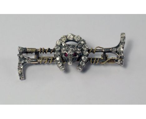 A diamond set fox head brooch, 19th/20th century, formed of two old cut diamond set gold riding crops, mounted with a fox hea