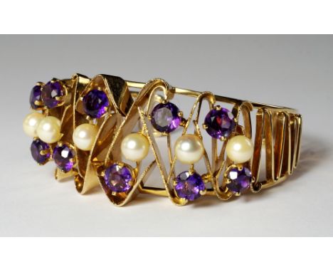 A 14ct gold bangle, c.1960s, of open form with zig-zag gold design, set with cultured pearls and amethysts, approx 2.5cm at w