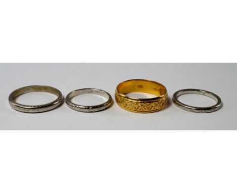Three platinum engraved wedding bands, approx sizes J, J/K and P, approx 9.3g, together with a 22ct gold engraved wedding ban