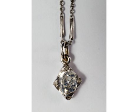 A single stone diamond pendant, the oval cut diamond approx 0.50ct set in white metal with diamond chips to the compass point